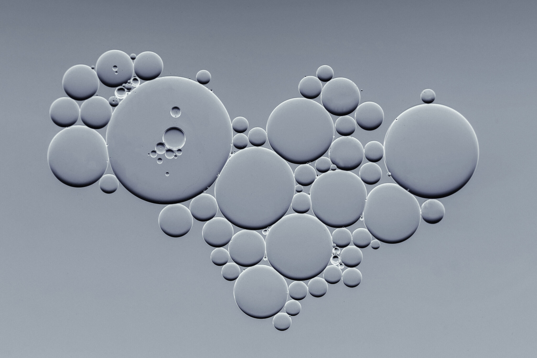 Greyscale cluster of embossed circles of varying sizes
